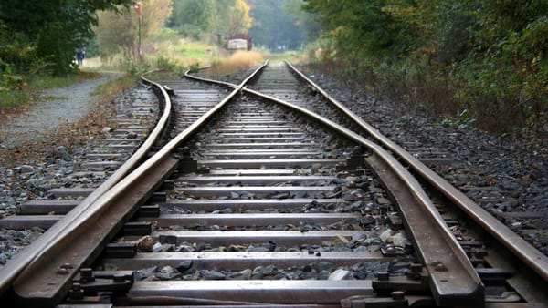 Railroad tracks with a track switch leading to a holding siding